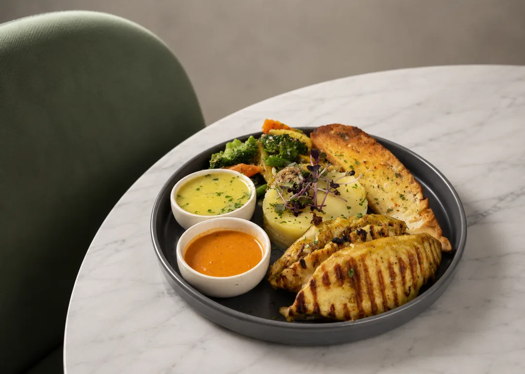 Fresh pan-seared river fish fillet finished with lemon caper herb butter and seasonal greens.